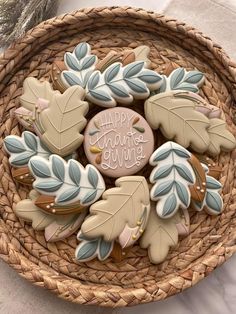 cookies decorated with leaves are in a wicker basket