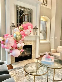 a living room filled with furniture and balloons on the fireplace mantels in front of a fire place