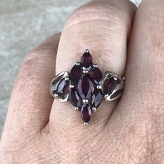 Garnet Cluster Ring Sz 7/Sterling Silver/Genuine 5.4ct Marquise Cut/Rhodolite Garnet/Signed/Pink Purple Garnet/Vintage Estate/Ring For Women Description Beautiful rhodolite garnet ring in excellent vintage condition. A total of 5.4ct of genuine, marquise cut garnet set in designer signed stamped 925 sterling silver setting. Face of ring measures 20mm from top to bottom and has a weight of 5.1g. Gorgeous pink purple color and fantastic sparkle! Size 7. All Gems tested with Presidium Gem Tester. A Marquise Cut Garnet Gemstone Ring, Garnet Marquise Cut Jewelry Gift, Marquise Cut Garnet Jewelry Gift, Marquise Garnet Red Rings, Red Garnet Multi-stone Rings, Garnet Ring Vintage, Garnet Wedding, Rhodolite Garnet Ring, Star Garnet