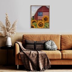 a living room with a brown couch and sunflowers