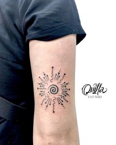 a person with a tattoo on their arm that has arrows in the shape of an eye