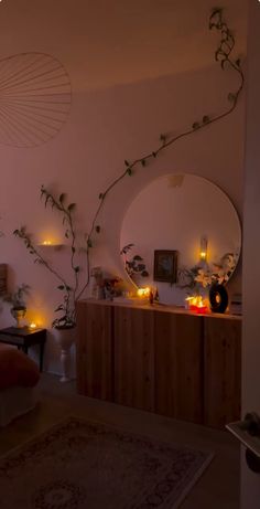 a living room filled with lots of furniture next to a wall covered in plants and candles