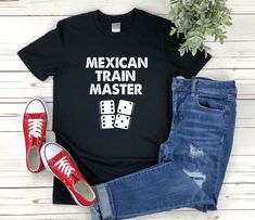 a t - shirt that says mexican train master with dominos on it and red sneakers