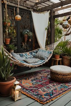 a hammock hanging from the ceiling in a room filled with potted plants