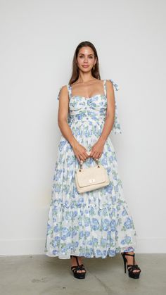 Indulge in the epitome of elegance with this delicate floral maxi dress adorned with a mesmerizing floral white design. Features: Maxi Floral Princess Seam Model is wearing a small 81380 A9-3 White Floor-length Midi Dress For Spring, Feminine Maxi Dress For Garden Party, White Floor-length Dress For Day Out, Feminine Floral Maxi Dress For Vacation, Elegant Sleeveless Maxi Dress For Garden Party, Beach Maxi Dress With Floral Print For Garden Party, Floral Print Maxi Dress For Beach Garden Party, Feminine Floral Print Maxi Dress For Day Out, Feminine Floral Maxi Dress For Garden Party