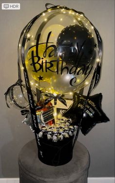 a birthday gift basket with balloons and confetti for someone's special occasion