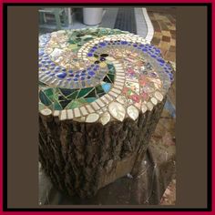 a tree stump with a mosaic design on it