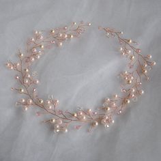 a headband with pearls and leaves on it