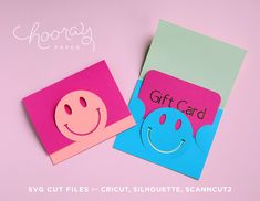 two paper cards with smiley faces on them, one has a gift card and the other has a happy face