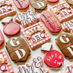 many decorated cookies are displayed on a white tablecloth with pink and red gingham