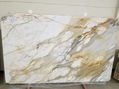 a large marble slab sitting on top of a wooden pallet in a room filled with boxes