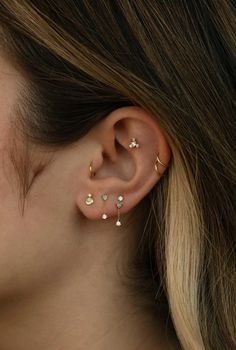 a woman's ear with three small stars on it