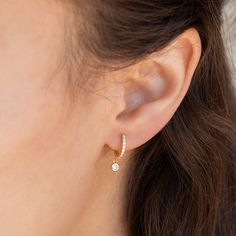 Elevate your everyday look with these elegant Diamond Huggie earrings. Dress up any outfit with these dainty pave hoops, perfect for wearing around the house or for a special occasion.• Material: High Quality Solid 925 Sterling Silver• Finish: Sterling Silver ∙ 18K Gold• Dimensions: Inner Diameter: 8mm Outer Diameter: 11mm• Featuring Dainty Pave Hoops with a dangling 3mm CZ Diamond stone SKU: RR-ER227 Elegant Earing Design, Everyday Earrings Simple Classy Gold, Minimalist Diamond Jewelry, Denty Jwellery, Gold Dainty Earrings, Simple Earrings Gold Indian, Dainty Earing, Earings Design Modern, Ring Earrings Gold