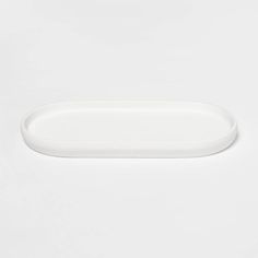 an empty white plate on a white surface