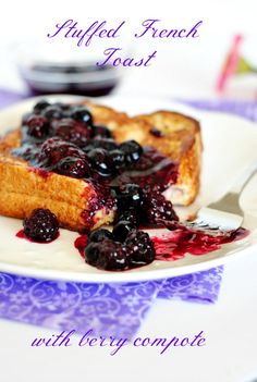 blueberry french toast with berry compote on white plate