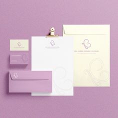 the stationery is laid out neatly on top of each other, including envelopes and business cards