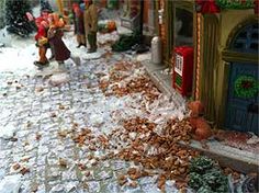 there are many toy figurines in front of a store window covered with snow