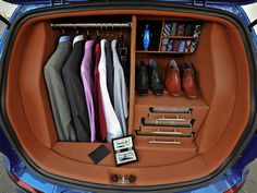 an open car trunk filled with clothes and shoes