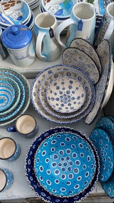 a table topped with lots of blue and white dishes