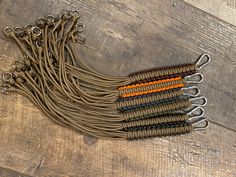 a bunch of brown and orange cords on top of a wooden floor next to each other