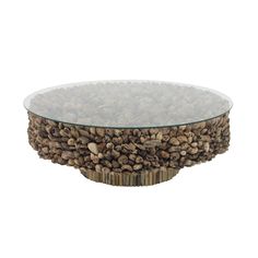 a glass and wood coffee table with rocks on it's base, in the shape of a bowl