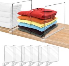 stack of folded shirts on wooden shelf with clear acrylic holders for each shirt