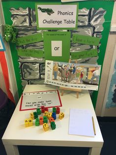 a table with some legos on top of it and a sign that says phonics challenge table