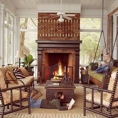 a living room filled with furniture and a fire place in the middle of a room