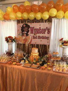 there is a table with many desserts on it and balloons in the air above