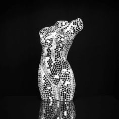 a black and white photo of a bear made out of mosaic tiles on a reflective surface