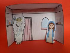 a paper cut out of the inside of a house with an image of jesus and mary