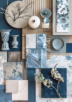 blue and white art work with vases, flowers and other items on the wall