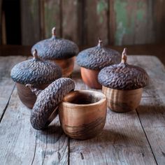 three wooden bowls with some kind of food in them on a table next to each other