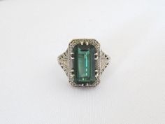 Vintage Sterling Silver Emerald Filigree Ring...Marked 925...Total of weights 5.6grams.. Size 8....Measure of Face 18mm...It's in good condition Elegant Engraved Emerald Ring For Formal Occasions, Green Sterling Silver Art Deco Jewelry, Art Deco May Birthstone Jewelry For Formal Occasions, Formal Emerald Jewelry With Filigree Detail, Elegant Engraved Green Rings, Formal Emerald Ring With Intricate Design, Elegant Green Engraved Rings, Formal Emerald Filigree Jewelry, Formal Green Jewelry With Intricate Design