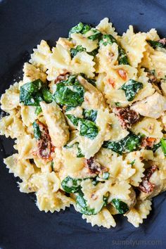 pasta with spinach and chicken in a blue bowl