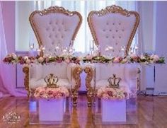 there are two chairs that have been decorated with flowers and gold trimmings on them