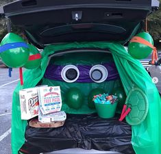 the trunk of a car is decorated in green and has an image of a monster on it