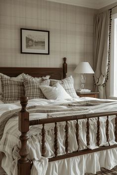 a large bed sitting next to a window in a room with curtains on the windowsill