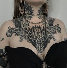 a woman with tattoos on her neck and chest