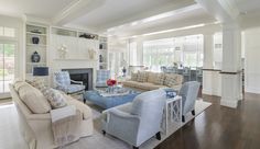 a living room filled with furniture and a fire place in the middle of a room