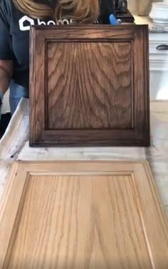 a woman is working on an unfinished cabinet in the kitchen with wood grain and glue