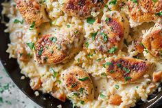 chicken and rice casserole with parsley garnish in a cast iron skillet