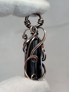 This listing is for an oxidized copper pendant created by me, in my 'Tyet' style.  The crystal is a beautiful and gemmy Black Tourmaline. This crystal is in it's raw, natural state.  Dimensions: 45mm x 13mm x 11mm Weight: 8 grams This pendant comes ready to wear with a free chain and polishing cloth.  The photos are of the item you will receive. Please note the size of the item featuring a US Quarter for reference. Thanks for looking! Black Tourmaline Necklace, Wire Wrap Pendant, Oxidized Copper, Tourmaline Necklace, Copper Pendant, Copper Pendants, Black Tourmaline, Wrapped Pendant, Wire Wrapped Pendant