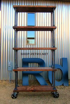 a metal and wood shelf sitting in front of a building