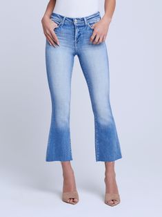 A high-rise cropped flare jean in in light-blue premium stretch denim. Hugs from waistband to knee before extending into a flared cropped leg finished with raw hem. Meticulous sanding on hip, thigh, and seat gives denim a vintage look. Classic five-pocket construction and front zip fly closure. Medium Wash Flared Hem Jeans For Spring, Denim Bottoms With Frayed Flared Hem, Spring Medium Wash Flared Hem Jeans, Flare Cropped Jeans In Medium Wash For Fall, Spring Flared Hem Jeans With Frayed Edge, Medium Wash Jeans With Frayed Flared Hem, Light Wash Flare Cropped Denim Jeans, Light Wash Flare Cropped Jeans, Flare Light Wash Cropped Denim Jeans