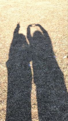 the shadow of two people and a dog