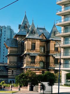 an old wooden building with many windows on the top floor and two balconies