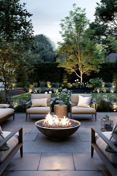 an outdoor fire pit surrounded by chairs and trees