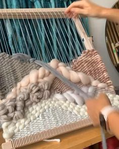 a woman is weaving wool with an apple watch