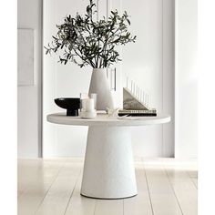 a white table with flowers and candles on it